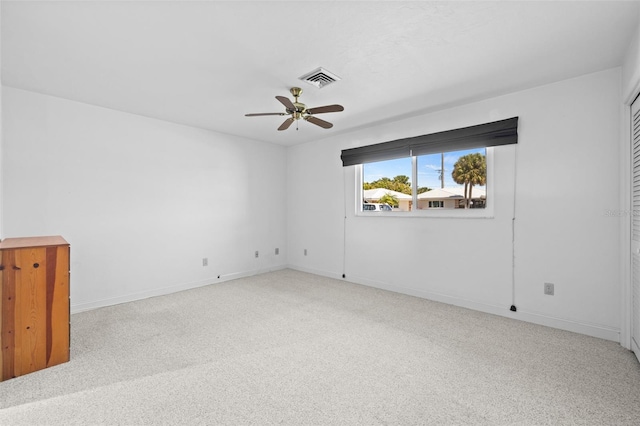 empty room featuring light colored carpet and ceiling fan