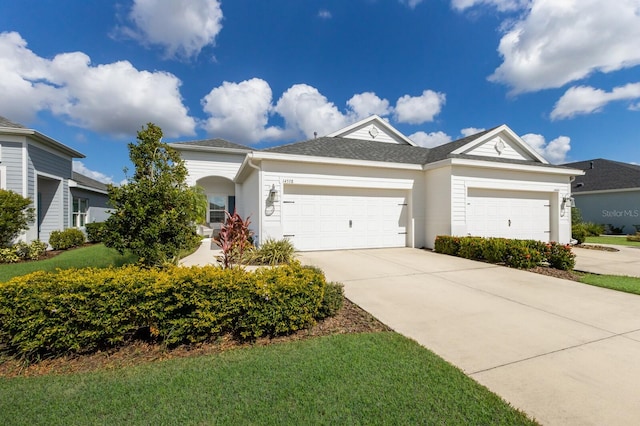 ranch-style house featuring a garage and a front lawn