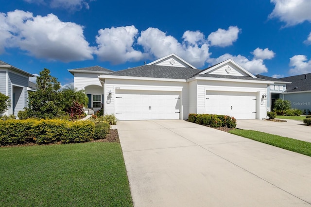 14538 Barefoot Ln, Parrish, FL 34219 - ranch-style house featuring an attached garage, concrete driveway, a front lawn, and roof with shingles