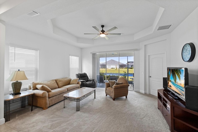 14538 Barefoot Ln, Parrish, FL 34219 - living area featuring a tray ceiling, a ceiling fan, carpet, and baseboards