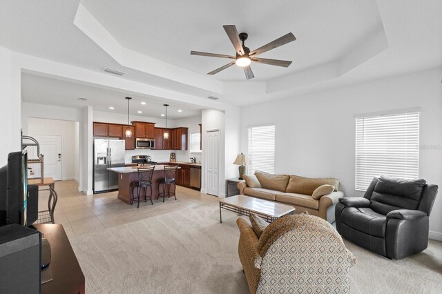 14538 Barefoot Ln, Parrish, FL 34219 - living room featuring a raised ceiling, a ceiling fan, recessed lighting, baseboards, and light tile patterned flooring