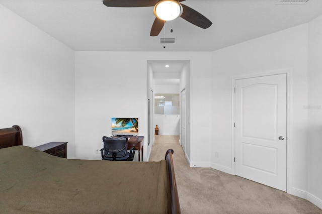 14538 Barefoot Ln, Parrish, FL 34219 - bedroom featuring light carpet, baseboards, ensuite bathroom, and ceiling fan