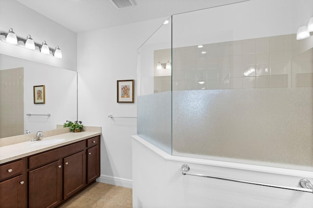 bathroom featuring vanity, tile patterned floors, and a shower