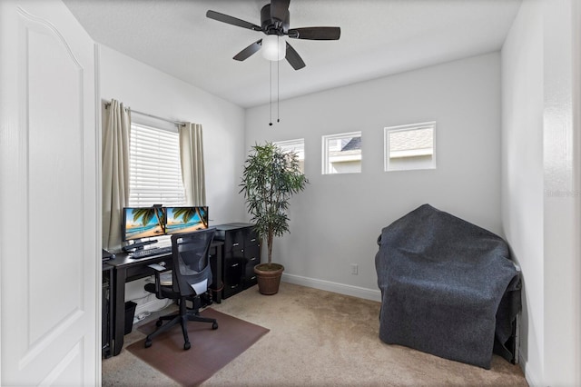 office with a wealth of natural light, light carpet, and ceiling fan