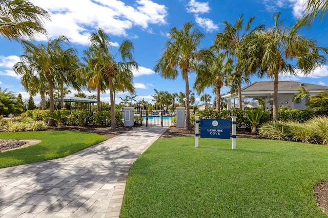 view of home's community featuring a yard and a pool