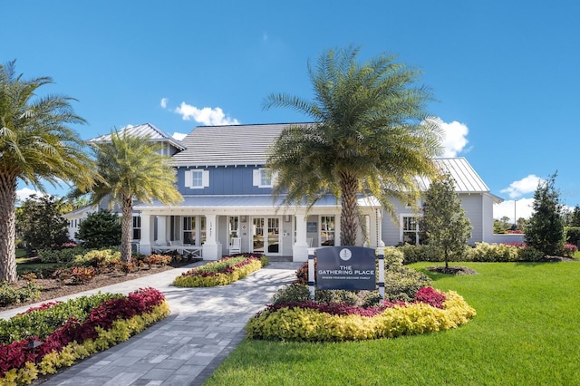 14538 Barefoot Ln, Parrish, FL 34219 - view of front of property with a front lawn, a standing seam roof, and board and batten siding