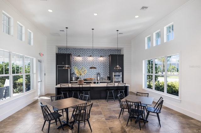 14538 Barefoot Ln, Parrish, FL 34219 - dining area featuring plenty of natural light, baseboards, an accent wall, recessed lighting, and crown molding