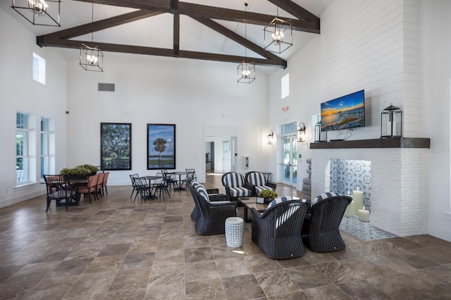 living room featuring high vaulted ceiling, a chandelier, and beam ceiling