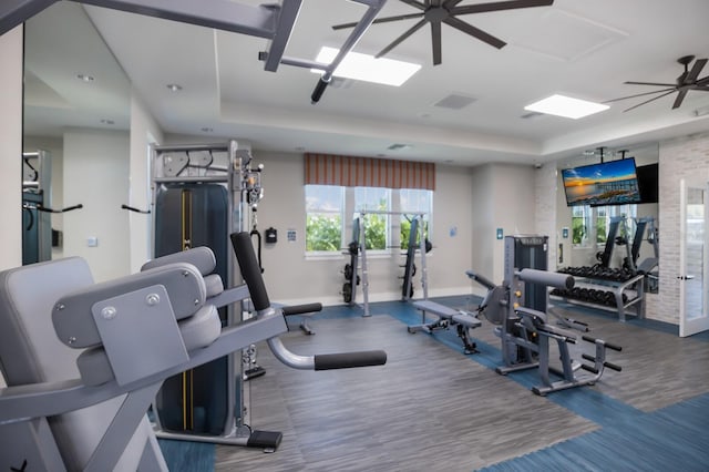 14538 Barefoot Ln, Parrish, FL 34219 - exercise room featuring baseboards, a tray ceiling, and ceiling fan