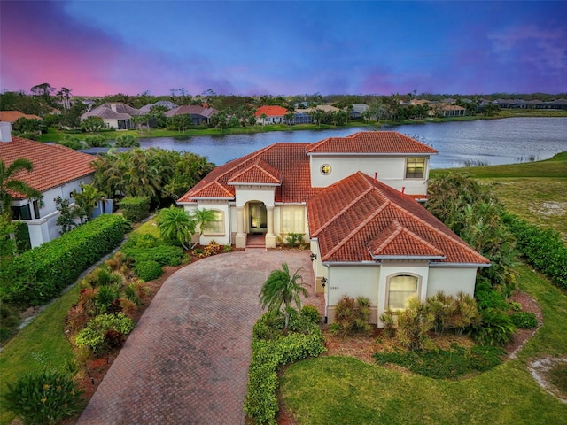 mediterranean / spanish-style home featuring a water view