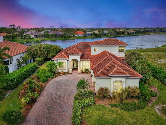 1509 Raphis Royale Blvd, Englewood, FL 34223 - mediterranean / spanish house featuring a tiled roof, a water view, and stucco siding