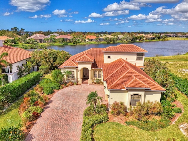 1509 Raphis Royale Blvd, Englewood, FL 34223 - mediterranean / spanish house with a tile roof, a water view, stucco siding, and decorative driveway