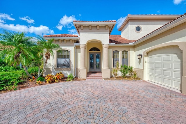 mediterranean / spanish home featuring french doors and a garage