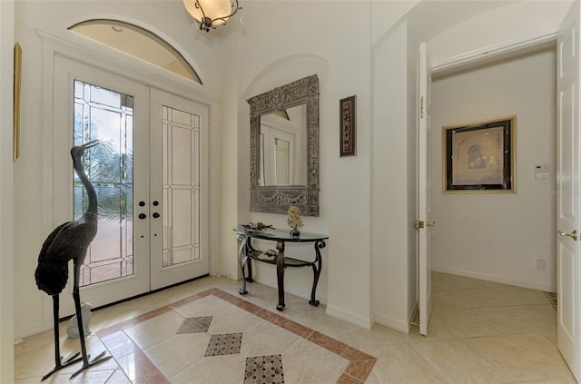 tiled foyer featuring french doors