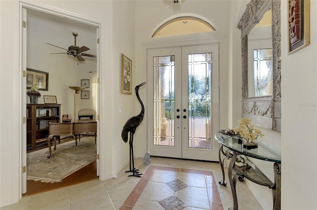 entrance foyer with french doors, ceiling fan, and light hardwood / wood-style flooring