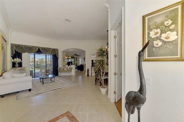1509 Raphis Royale Blvd, Englewood, FL 34223 - hallway with arched walkways, light tile patterned floors, and crown molding