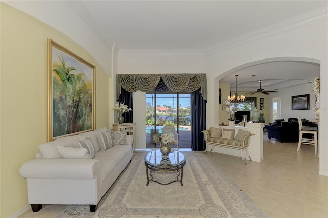 tiled living room with ceiling fan with notable chandelier and crown molding