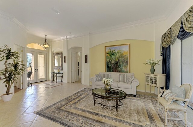 1509 Raphis Royale Blvd, Englewood, FL 34223 - living area with arched walkways, ornamental molding, light tile patterned floors, and french doors