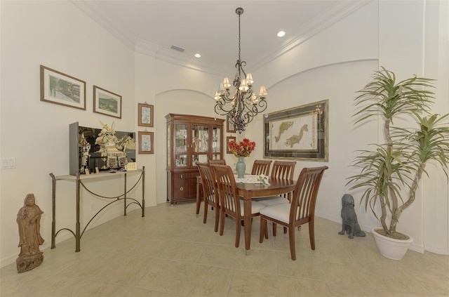 dining area featuring light tile patterned floors, a notable chandelier, and ornamental molding