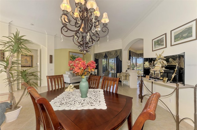 dining area with a notable chandelier, light tile patterned floors, and crown molding