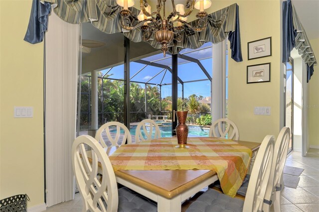 1509 Raphis Royale Blvd, Englewood, FL 34223 - dining area featuring a sunroom, baseboards, and a chandelier