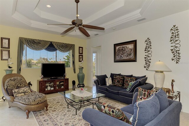 1509 Raphis Royale Blvd, Englewood, FL 34223 - living room featuring a tray ceiling, ceiling fan, and light tile patterned flooring