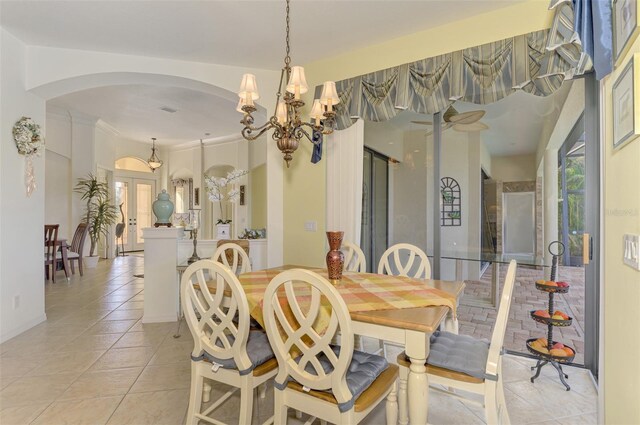 1509 Raphis Royale Blvd, Englewood, FL 34223 - dining area with arched walkways, a chandelier, and light tile patterned floors