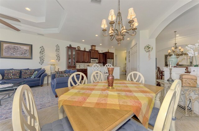 1509 Raphis Royale Blvd, Englewood, FL 34223 - dining space featuring a chandelier, arched walkways, recessed lighting, light tile patterned floors, and a ceiling fan