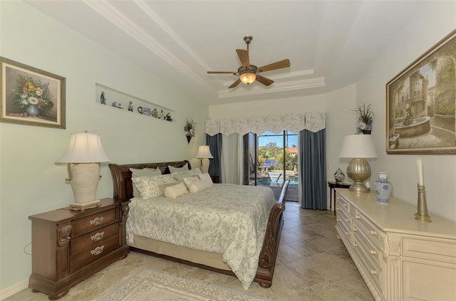 bedroom featuring a raised ceiling, ceiling fan, and access to exterior