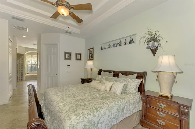 bedroom featuring ceiling fan and a raised ceiling