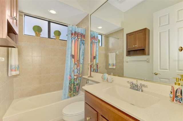 full bathroom featuring shower / bath combo with shower curtain, vanity, and toilet