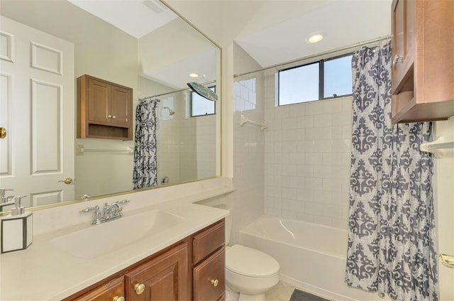 full bathroom featuring toilet, tile patterned floors, vanity, and shower / bath combo with shower curtain