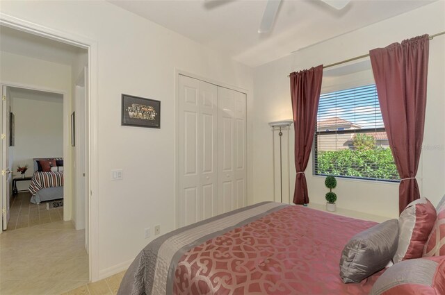 1509 Raphis Royale Blvd, Englewood, FL 34223 - bedroom featuring a closet, light tile patterned floors, a ceiling fan, and baseboards