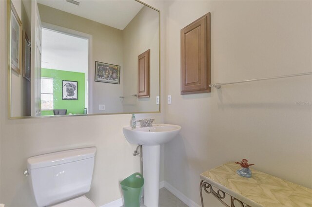 1509 Raphis Royale Blvd, Englewood, FL 34223 - bathroom with toilet, baseboards, and a sink