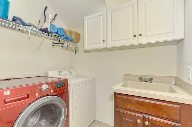 laundry room with cabinets, sink, and washer and dryer