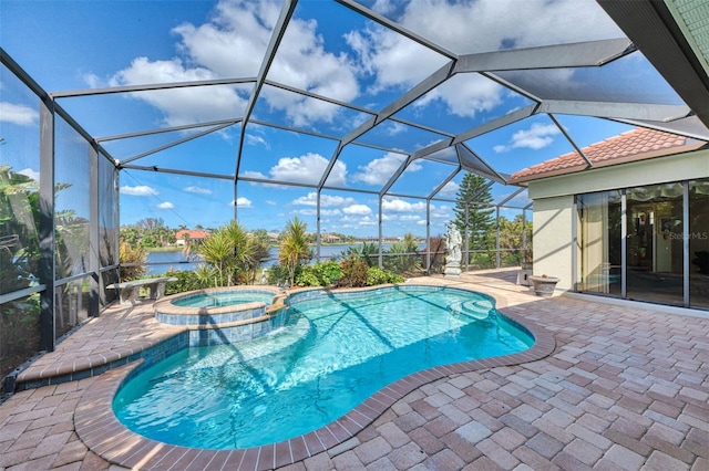 view of pool featuring a patio area, glass enclosure, a water view, and an in ground hot tub