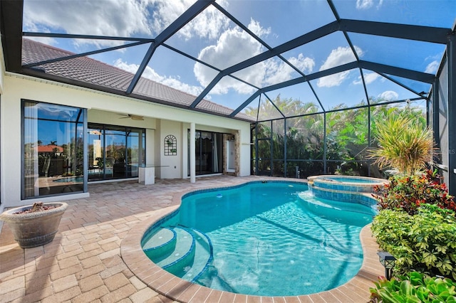 view of swimming pool featuring glass enclosure, ceiling fan, an in ground hot tub, and a patio area