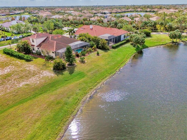 birds eye view of property with a water view