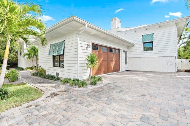 view of side of home featuring a garage