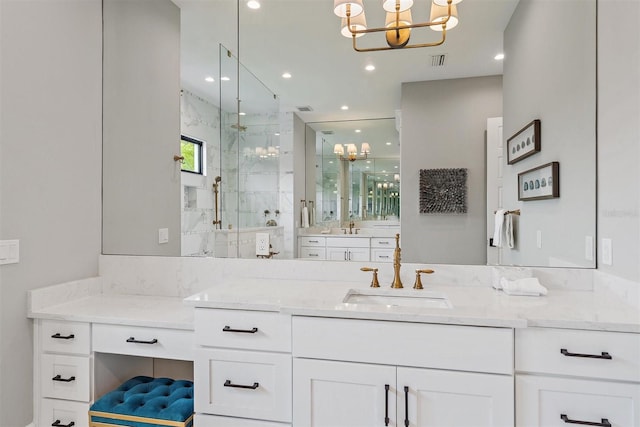 bathroom featuring a shower with shower door, vanity, and a notable chandelier