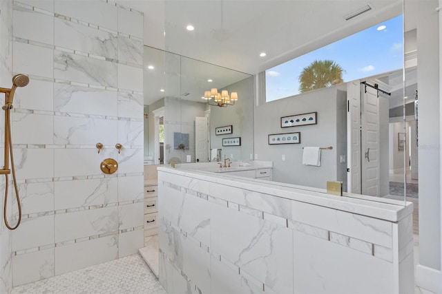 bathroom featuring vanity and tiled shower