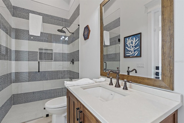 bathroom with toilet, a shower, and vanity