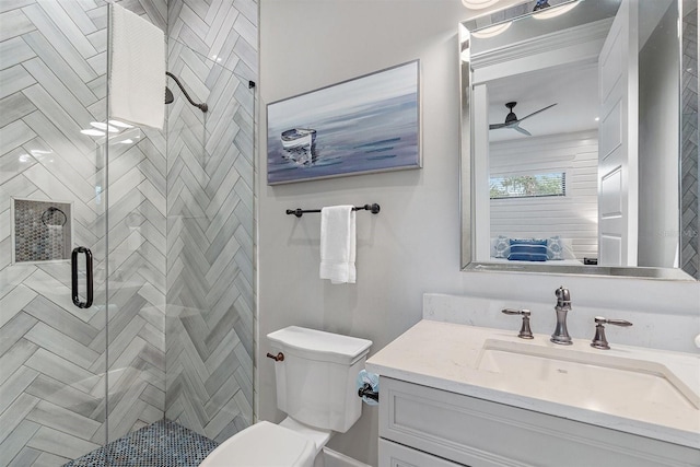 bathroom with toilet, ceiling fan, an enclosed shower, and vanity