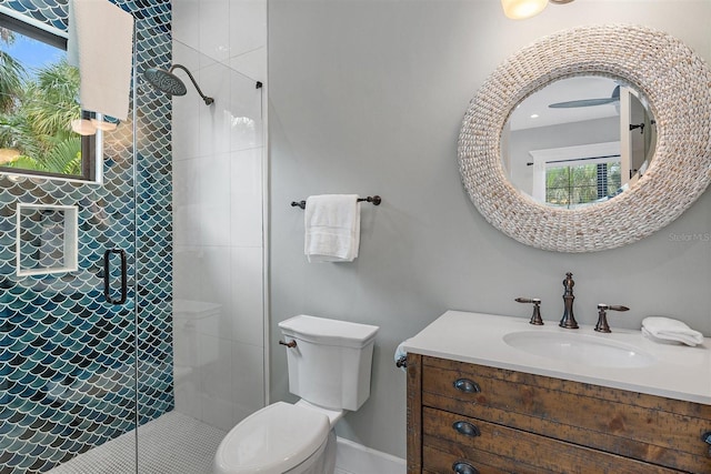 bathroom with toilet, vanity, and an enclosed shower