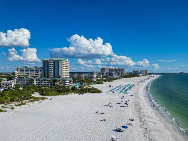 birds eye view of property with a view of the beach and a water view