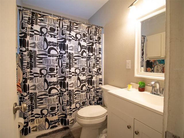 bathroom with toilet, vanity, and walk in shower