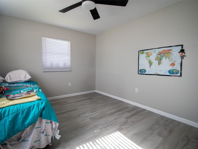 unfurnished bedroom featuring hardwood / wood-style floors and ceiling fan