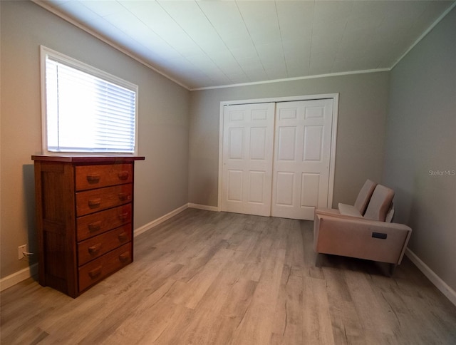 sitting room with light hardwood / wood-style flooring and crown molding