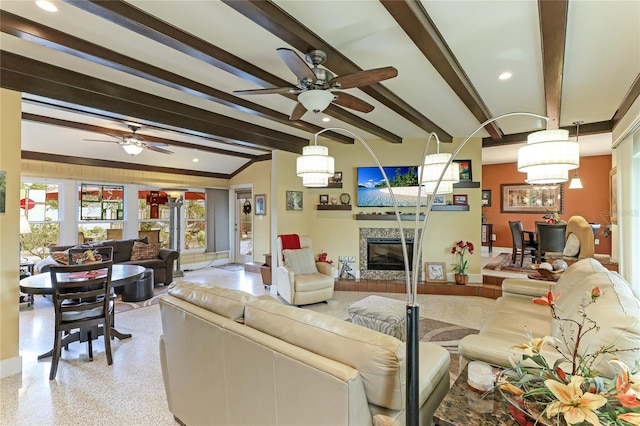 living room with ceiling fan with notable chandelier and beam ceiling