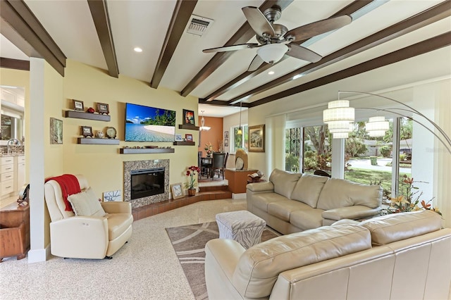 living room with beamed ceiling, ceiling fan, and sink